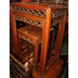 A nest of three Chinese hardwood occasional tables, on moulded and stretchered supports, largest