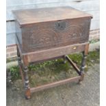 A 17th century oak boarded lace box with lunette panel front, on near contemporary stand with turned