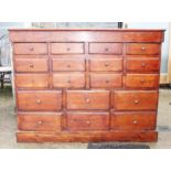 An apothecary's polished as mahogany cabinet of fifteen drawers with brass knob handles, on block