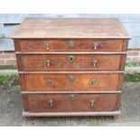 An 18th century oak, figured walnut and banded chest of four graduated drawers with brass drop