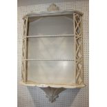 A chinoiserie design white painted three-tier wall shelf, 24" wide x 8" deep x 42" high