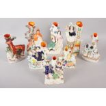 Eight Staffordshire figure spill vases, including Little Red Riding Hood, 10" high, and two babes in