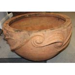 An Arts & Crafts terracotta planter with relief scroll decoration, 24" dia x 13" high (restored