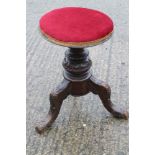 An early 20th century polished as mahogany adjustable circular seat piano stool, on tripod splay