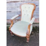 A pair of Victorian carved walnut showframe "ladies and gentlemen's" chairs, upholstered in a sage