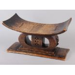 An Ashanti carved hardwood stool, 21" wide