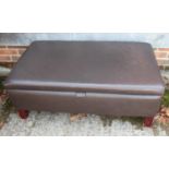 A box seat ottoman, upholstered in a chocolate leather, on square taper supports, 40" wide x 24"