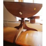 A mahogany drop leaf low occasional table, on turned column and tripod splay supports, 24" dia x 20"