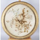 A 19th century silk embroidery of flowers, 16 1/2" dia, in a circular gilt frame