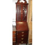 A hardwood bureau bookcase of Georgian design, fitted glazed cupboard over four doors, 22 1/2"