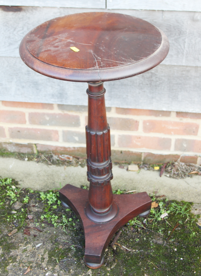 A 19th century Cuban mahogany circular top occasional table, on turned column and triform base, 14