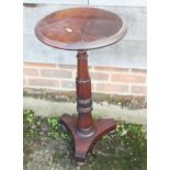 A 19th century Cuban mahogany circular top occasional table, on turned column and triform base, 14