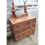 An Edwardian walnut dressing chest, fitted mirror, two jewel drawers over two short and two long