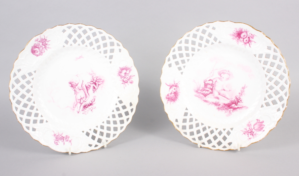 A pair of bone china plates with puce cherub and floral decoration with pierced borders, 9 1/2" dia