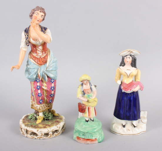 A Derby figure of a woman, 10" high, and two smaller figures (damages)