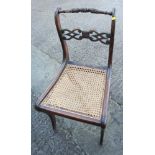A set of three Regency grained as rosewood bar back side chairs with caned panel seats (for