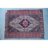 A Persian tribal rug with central star medallion on a blue floral ground, 36 1/2" x 53" approx