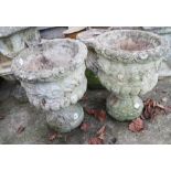 A pair of stone pedestal planters, decorated flowers and swags, 18" high