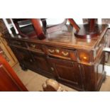 An oak and walnut dresser base, fitted three drawers over two cupboards, on bracket feet, 73" wide x