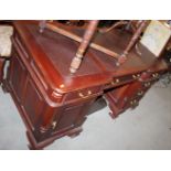 A partners hardwood double pedestal desk with fluted column corners, fitted two drawers and