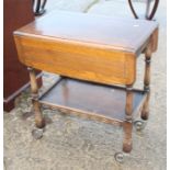 An oak two-tier tea trolley with drop leaves, on castored supports, 26" wide x 30" high