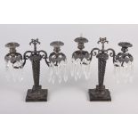 A pair of early 19th century bronze table lustre candelabra with twisted column, on square base,