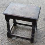 An oak joint stool of 17th century design, on turned and stretchered supports, 18" wide x 12" deep x