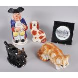 A Kensington Winstanley model of a cat, 3" high x 8" long, a Staffordshire Toby jug, 9 1/4" high,