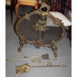 A Rococo brass and mesh firescreen, 31" high, and brass fire irons