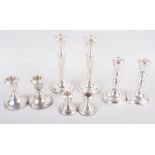 Three pairs of filled silver candlesticks, tallest 7 1/4" high, a single filled silver candlestick