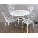 A white painted aluminium circular openwork garden table and a set of four similar armchairs