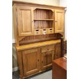 A French oak dresser, the upper section with central open shelves flanking cupboards and drawers