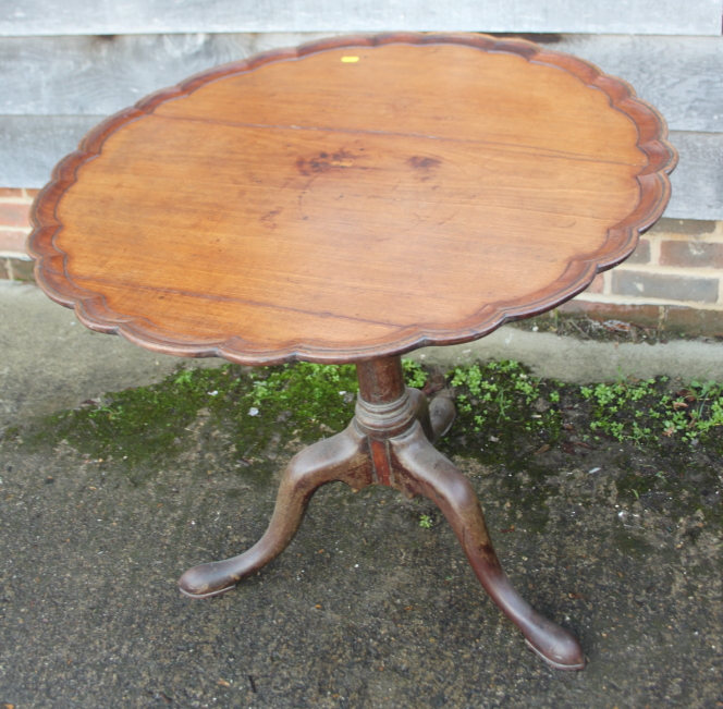 A 19th century mahogany piecrust tilt top occasional table, on baluster turned column and tripod