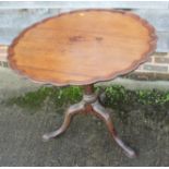 A 19th century mahogany piecrust tilt top occasional table, on baluster turned column and tripod