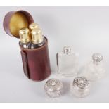 A silver topped glass hip flask, a silver topped scent bottle, a silver topped dressing table jar,