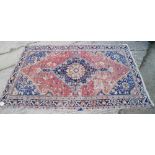 A Herati rug with floral and geometric designs, central medallion and multi bordered on a red ground