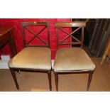 A pair of early 19th century mahogany 'X' back dining chairs with stuffed over seats, on turned