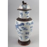 A Chinese crackle glazed jar and cover with dragon cloud scroll decoration, 14" high (cover