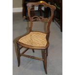 A late Victorian grained as rosewood carved bar back side chair with caned panel seat