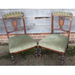 Three late 19th century mahogany and inlaid splat back salon chairs with upholstered top rails, on