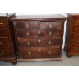 An early 18th century provincial yew wood chest of two short and three long drawers with embossed