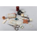 A selection of vintage sewing accessories, including tape measures, mother-of-pearl cotton