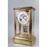 A 19th century brass four-glass clock with white enamel and gilt dial, Roman numerals and mercury