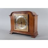 An Elliot walnut cased mantel clock with gilt and silvered dial and Roman numerals, 9 1/4" high