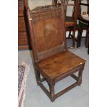 A late 17th century oak wainscot chair with panel seat, on turned and stretchered supports, 20" wide