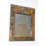A rectangular mirror, in deep aged frame with subsidiary round plate, central plate, 13" x 11", a