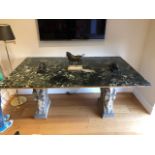 A green marble top dining table, on faux carved stone supports, top 68" x 40", 32" high