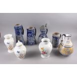 Four Rhenish stoneware jugs, tallest 12 1/2" high, an Italian jug, 10" high, a Kaiser floral