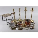 A 19th century pierced brass trivet, a cast iron smoothing iron stand, two pairs of brass