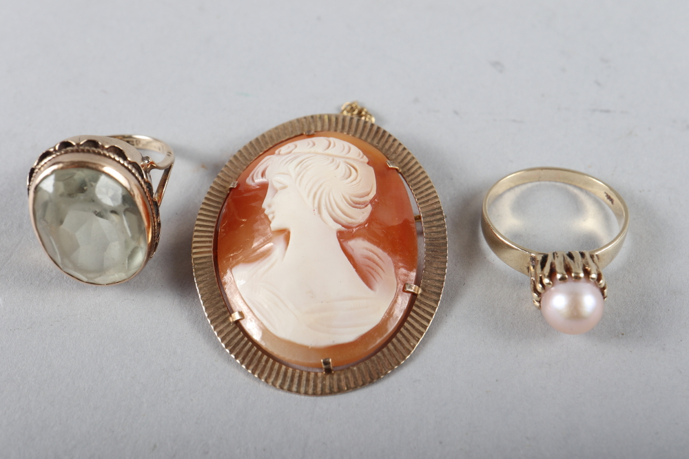 A cameo brooch in 9ct gold mount, a pearl set dress ring and a 9ct gold dress ring set topaz